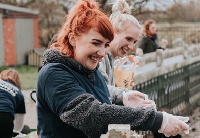 Two colleagues volunteering at a farm 