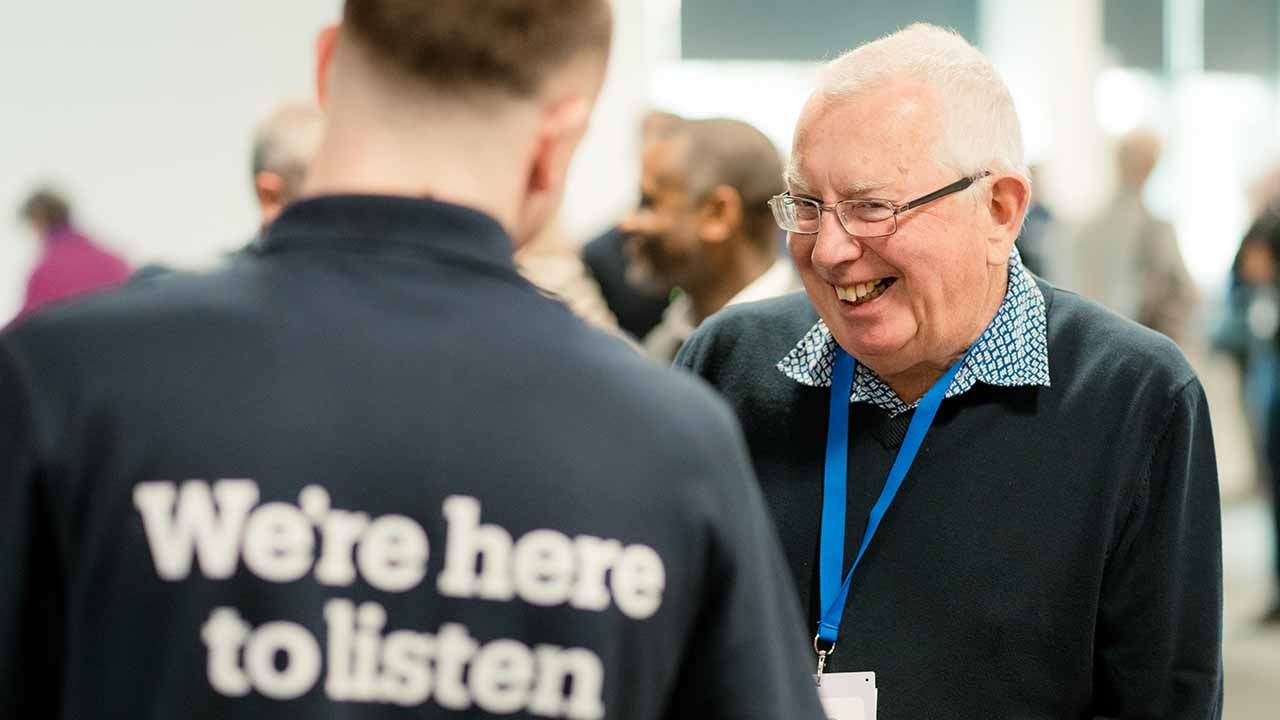 A man smiling at another man