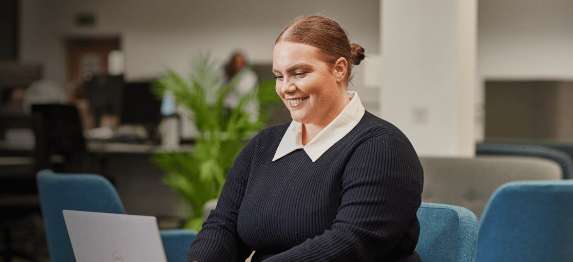A Newcastle for Intermediaries business development manager sitting at a desk, focused on her laptop, and engaged in her work.