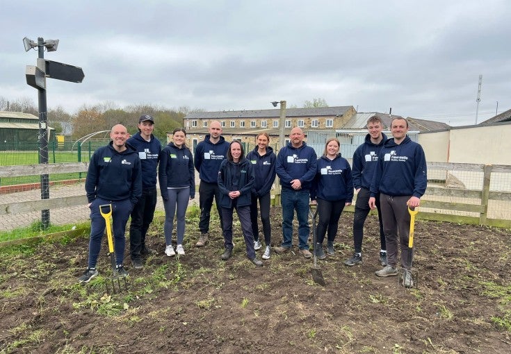 IT colleagues volunteering at Newcastle Dog & Cat Shelter to do some gardening. 
