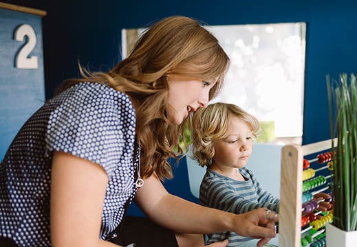 Newcastle Building Society branch colleague helps a little boy in our play branch in Tiny Toon. 