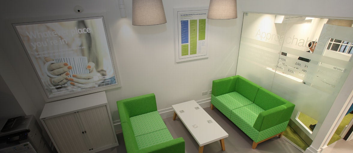 Interior of Carlisle branch showing a seating area and a private room. 