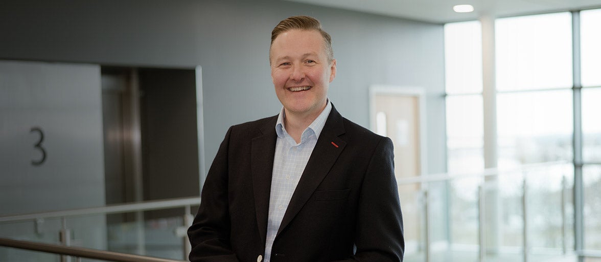 Executive, Nick Young, stood in Newcastle Building Societies head office. 