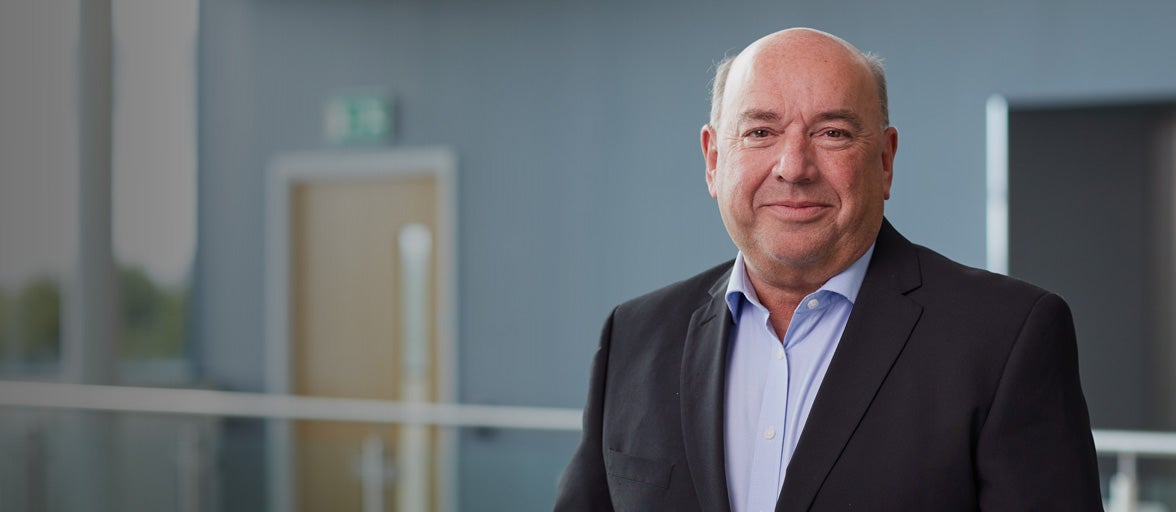 Bryce Glover smiling stood in Cobalt office