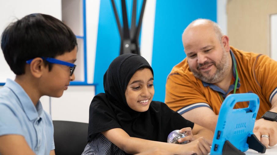 A group of people looking at an iPad at the Newcastle United Foundation