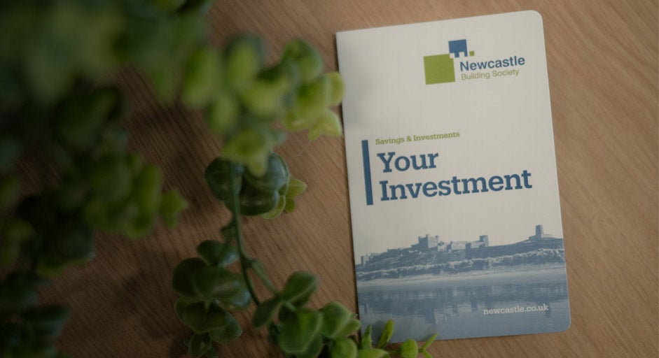 A Newcastle Building Society passbook laid on a table.