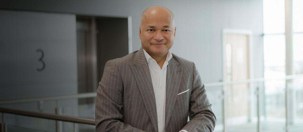 Professor Moorad Choudhry stood in Newcastle Building Society's head office. 