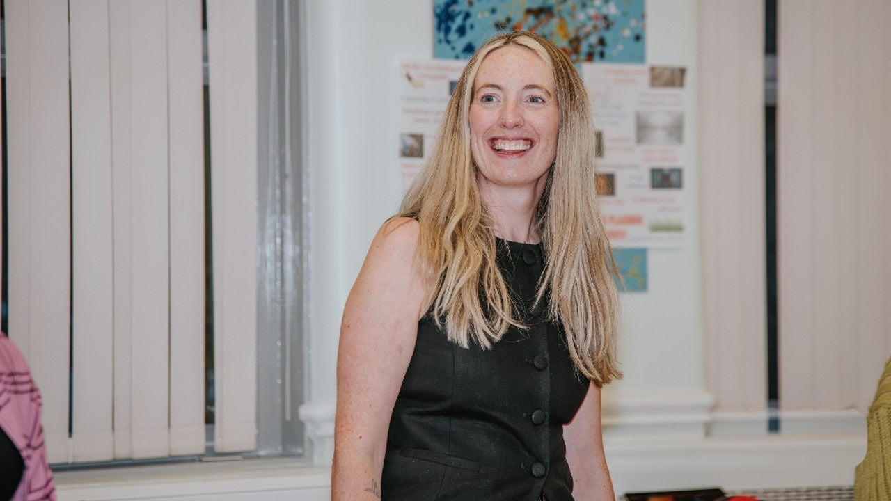 A woman stood smiling.