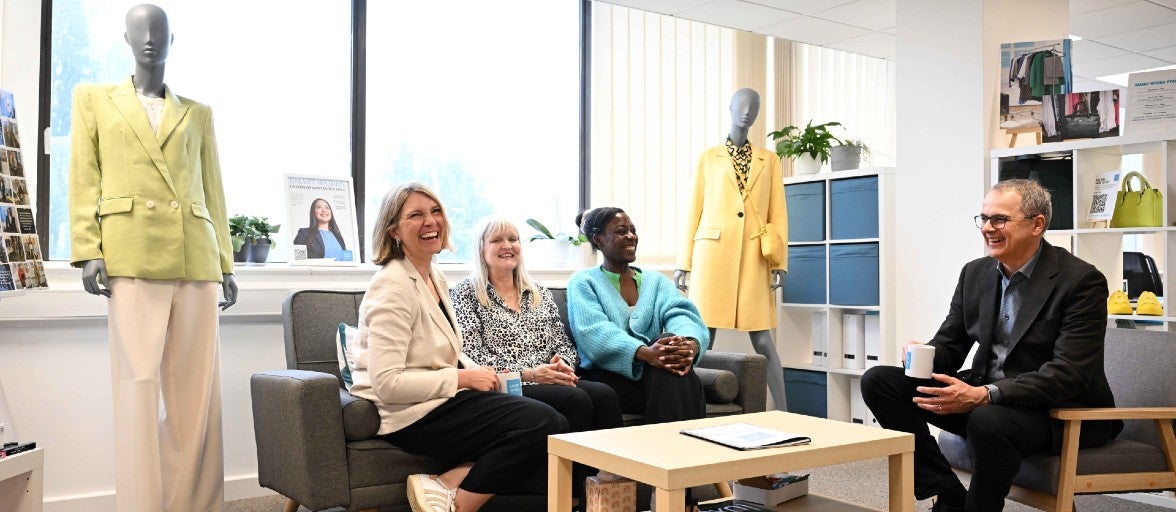 A group of people sitting on sofas in a room.