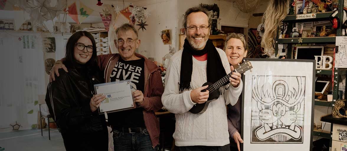 Four people involved with the RT Project in Durham, showing their community grant, received from Newcastle Building Society's, Newcastle Community Fund. 