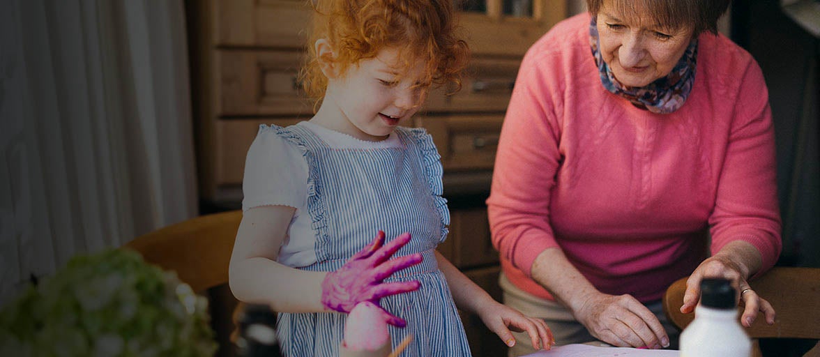 Grandmother doing some gardening with her young granddaughter.