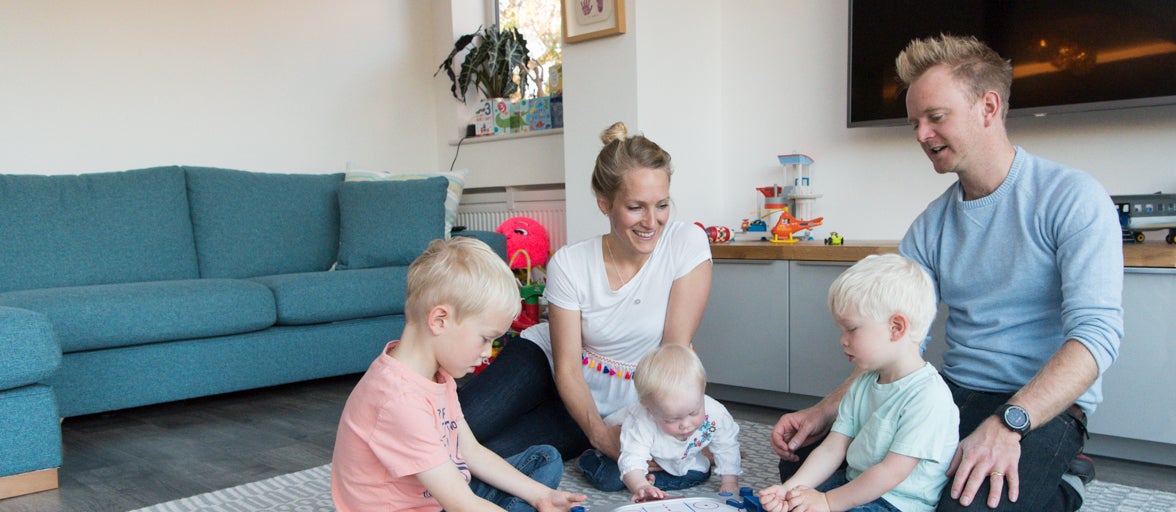 Family sat playing on the floor