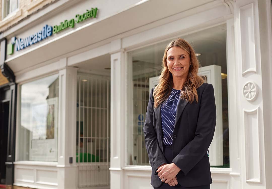 Durham's Branch Manager, Faye, stood in front of the branch smiling. 