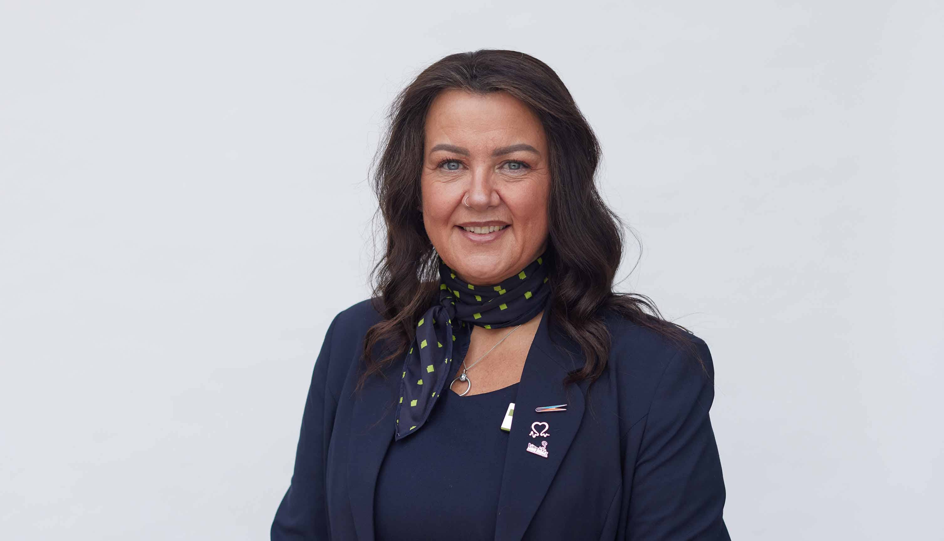 West Denton Branch Manager, Michelle. Stood smiling, white background. 