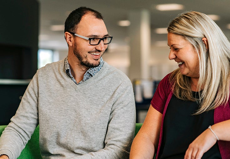 A man and woman share a joke