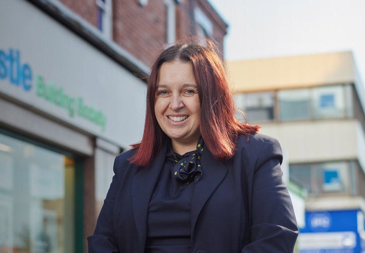Branch Manager of Hartlepool, Carrieanne, stood in front of the branch smiling. 