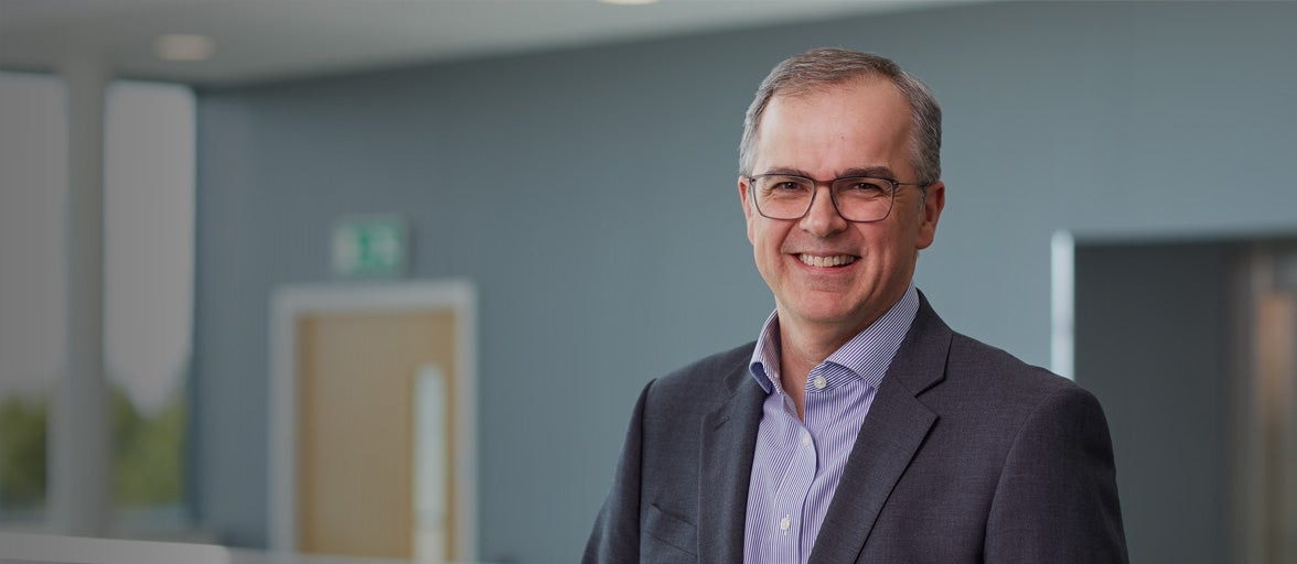 Board member of Newcastle Building Society, Andrew Haigh smiling in Cobalt office. 