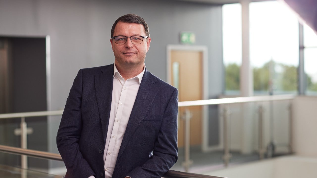 Michael Conville, Chief Customer Officer at Newcastle Building Society stood inside head office.