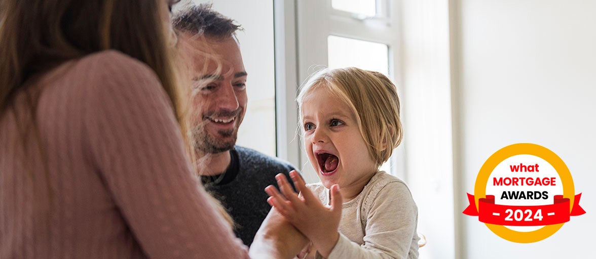 Family with little girl smiling and laughing. What Mortgage Awards 2024 logo on bottom right hand corner of the image. 