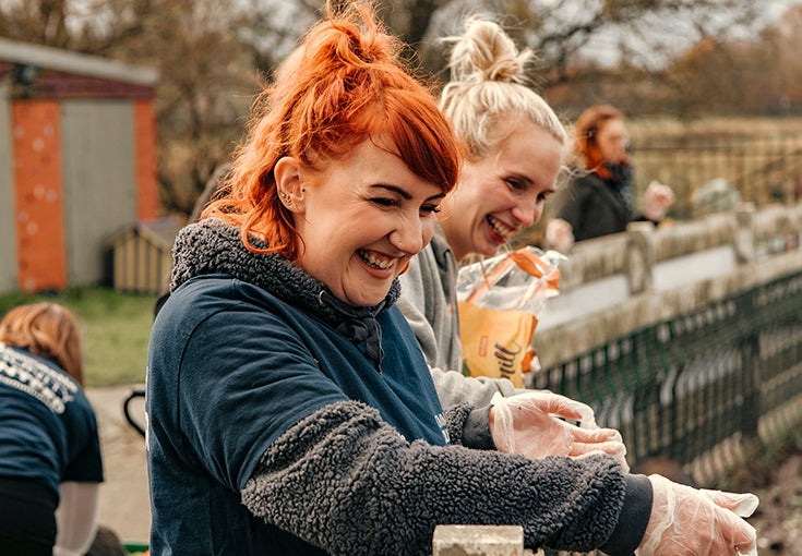 Two smiling volunteers