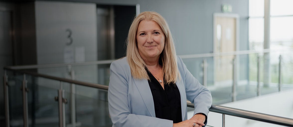 Board member, Karen McDonagh Reynolds, stood inside of Newcastle Building Societies head office. 