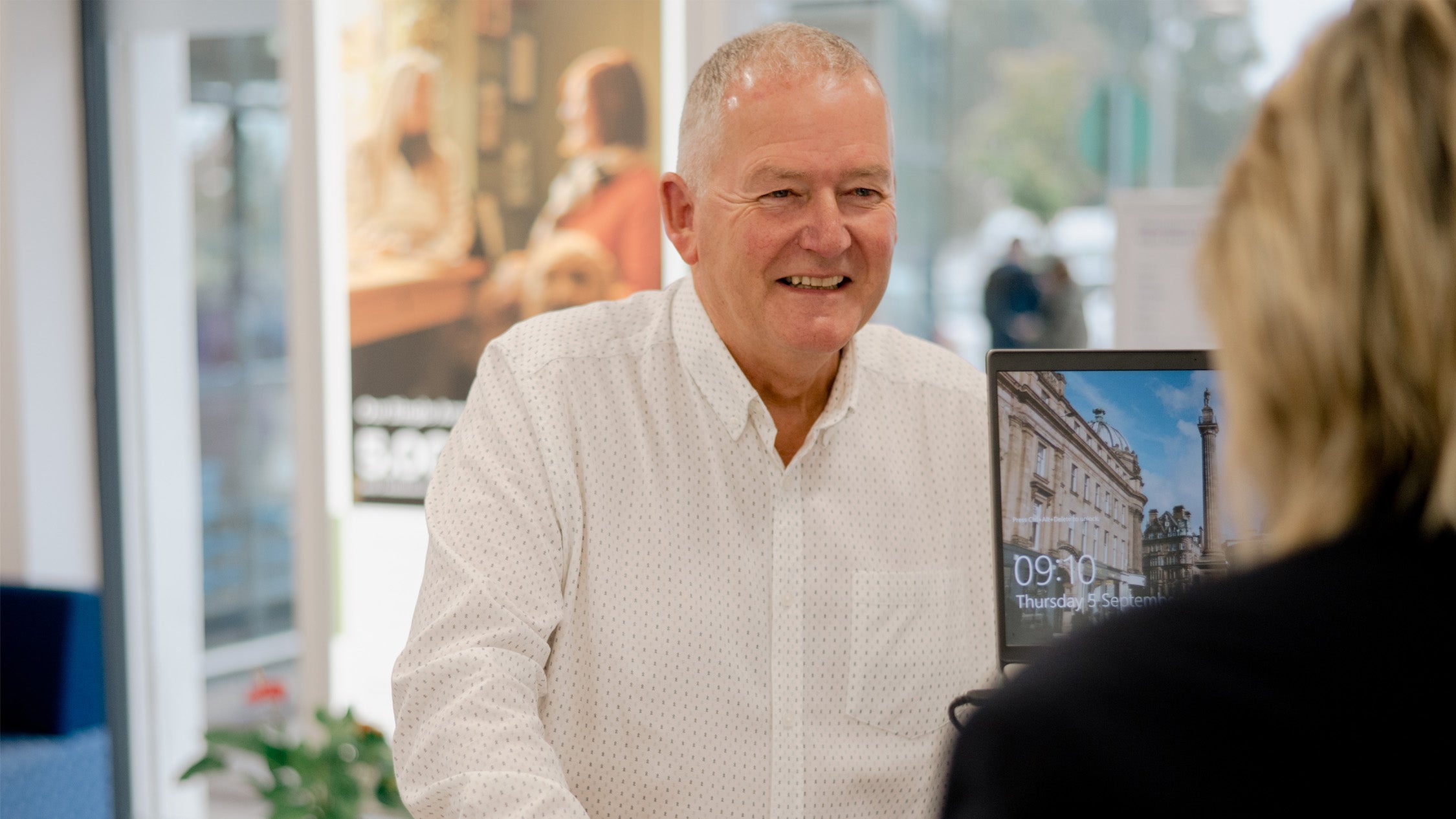 A member, smiling. Wearing a white shirt.