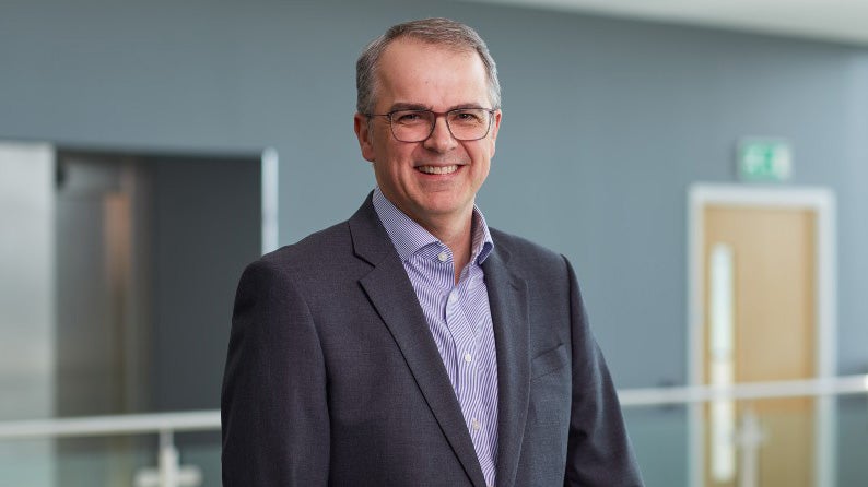 Andrew Haigh stood in head office smiling.