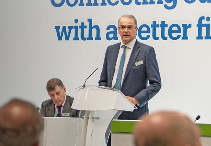 Andrew Haigh stood in front of Newcastle Building Society Members, delivering a speech. 