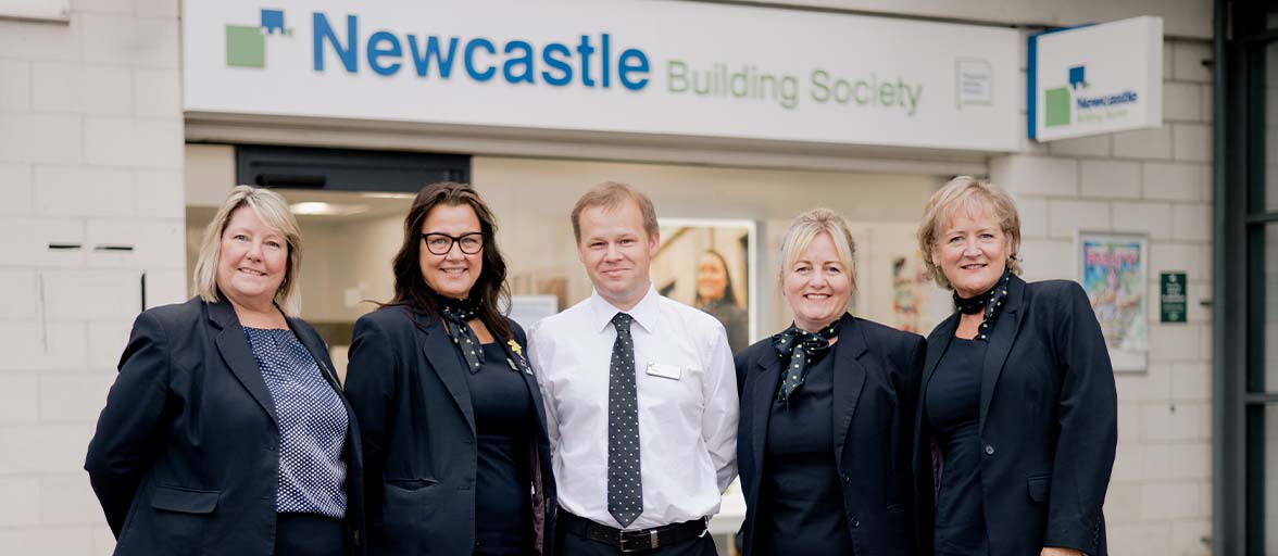 A group of people standing in front of a building