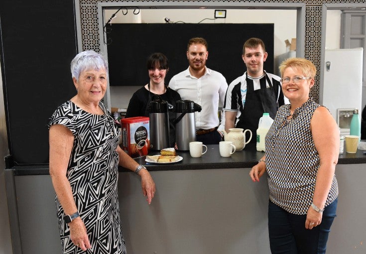 Skills4Work group stood with cups of tea and coffee