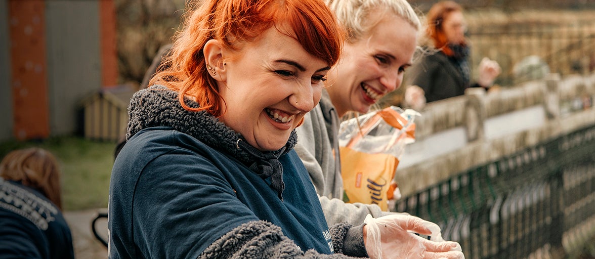 Two colleagues volunteering at the Cat and Dog Shelter 