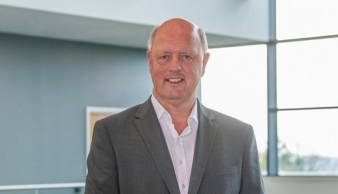 Adam Bennett smiling in Cobalt office.