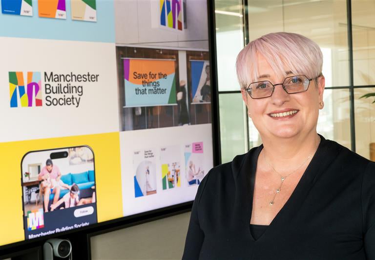 Deborah Walker stood in front of a digital screen