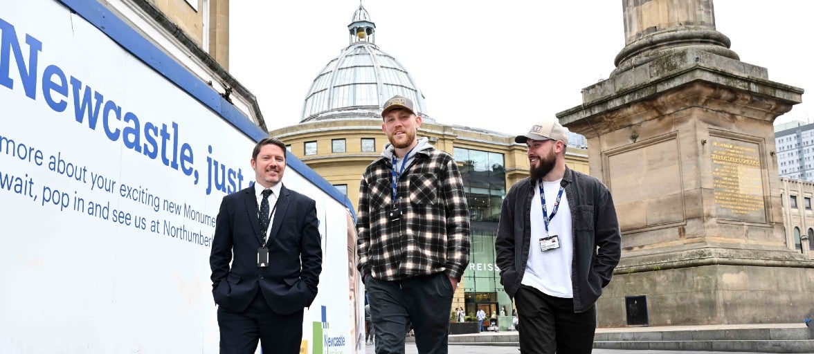 A group of men walking down a street.
