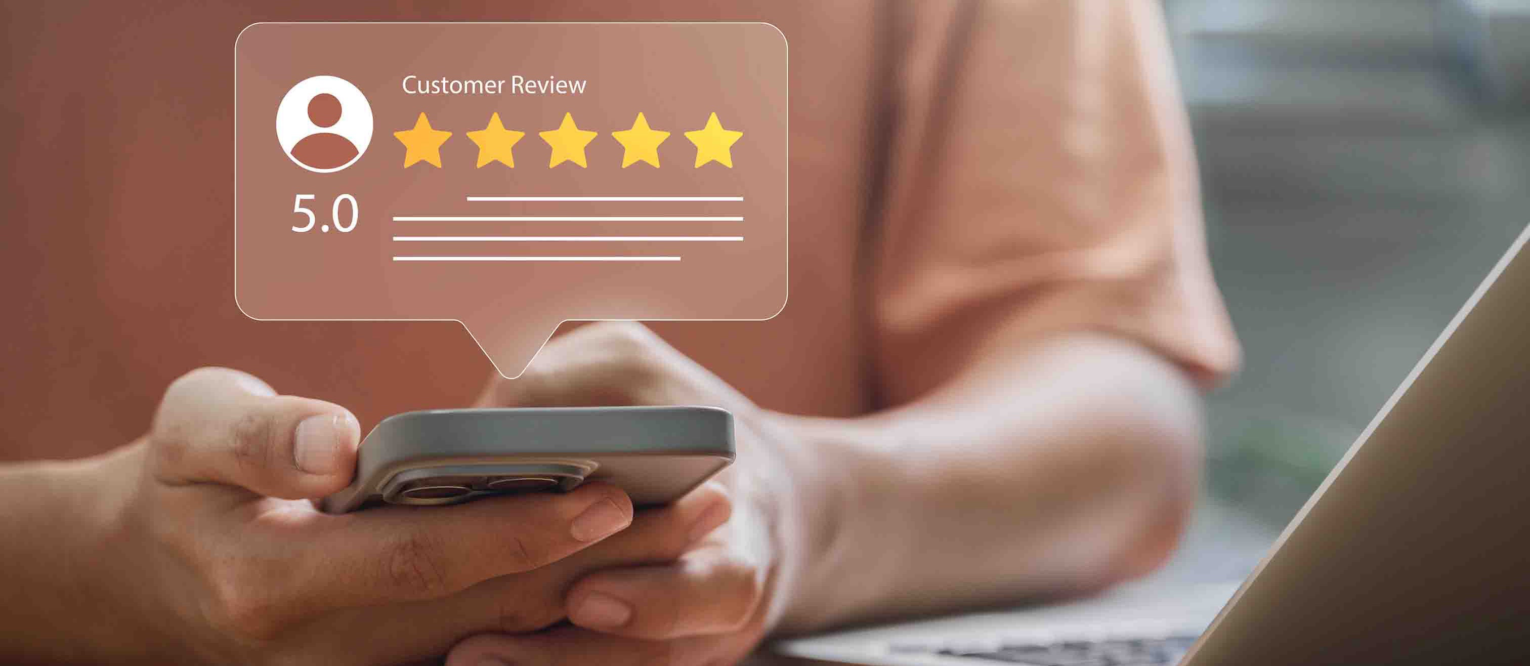A person holding a phone with a 5 star customer review popping up from their screen