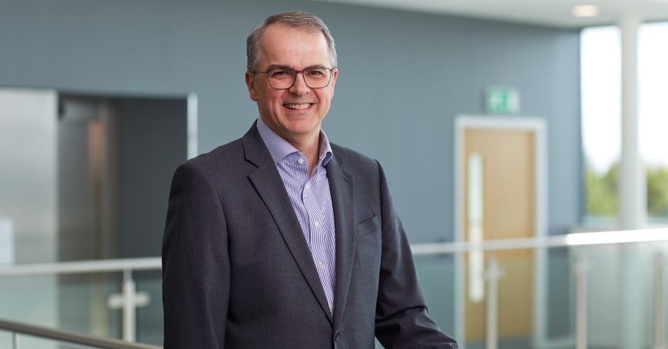 Newcastle Building Society CEO, Andrew Haigh, stood smiling inside their Cobalt office.
