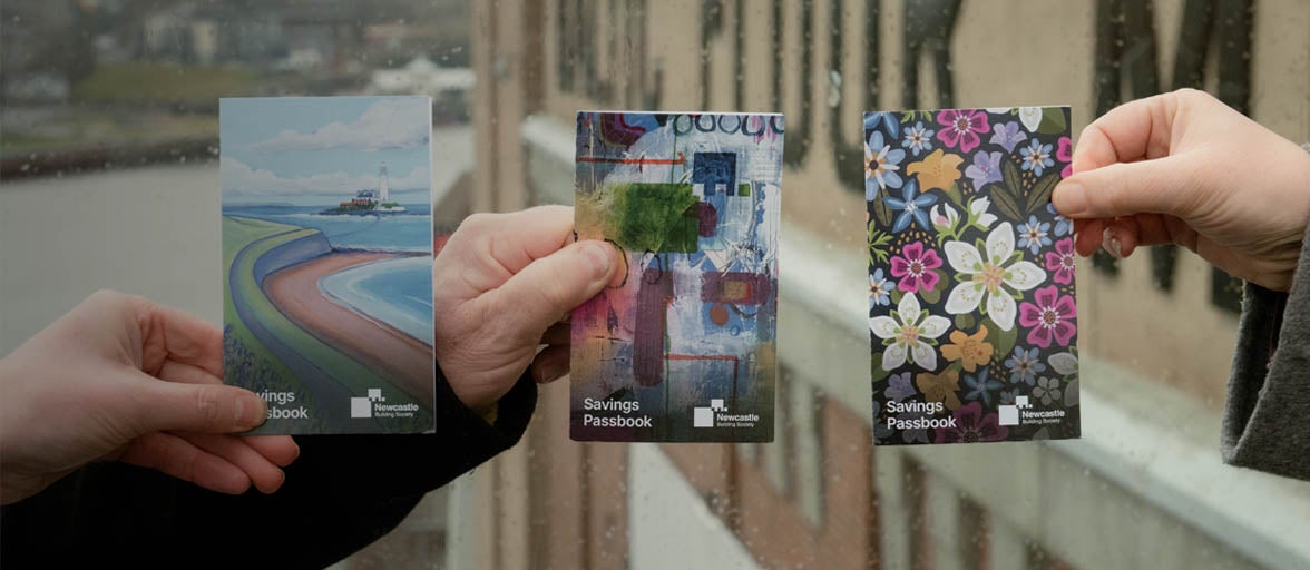 Hands holding passbooks. 