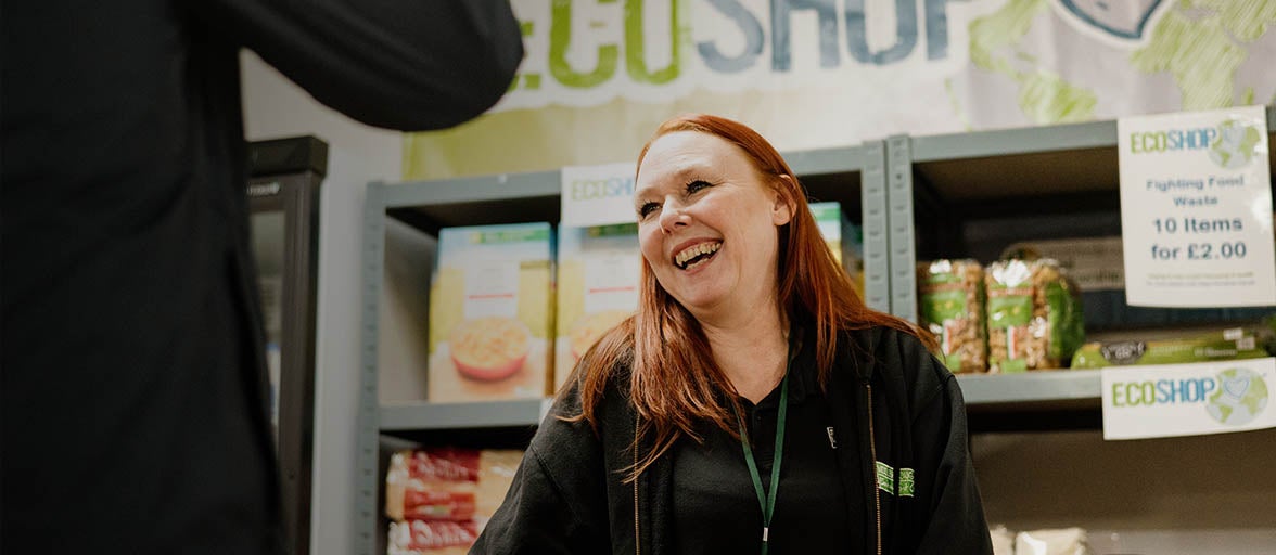 A woman smiling at a food pantry