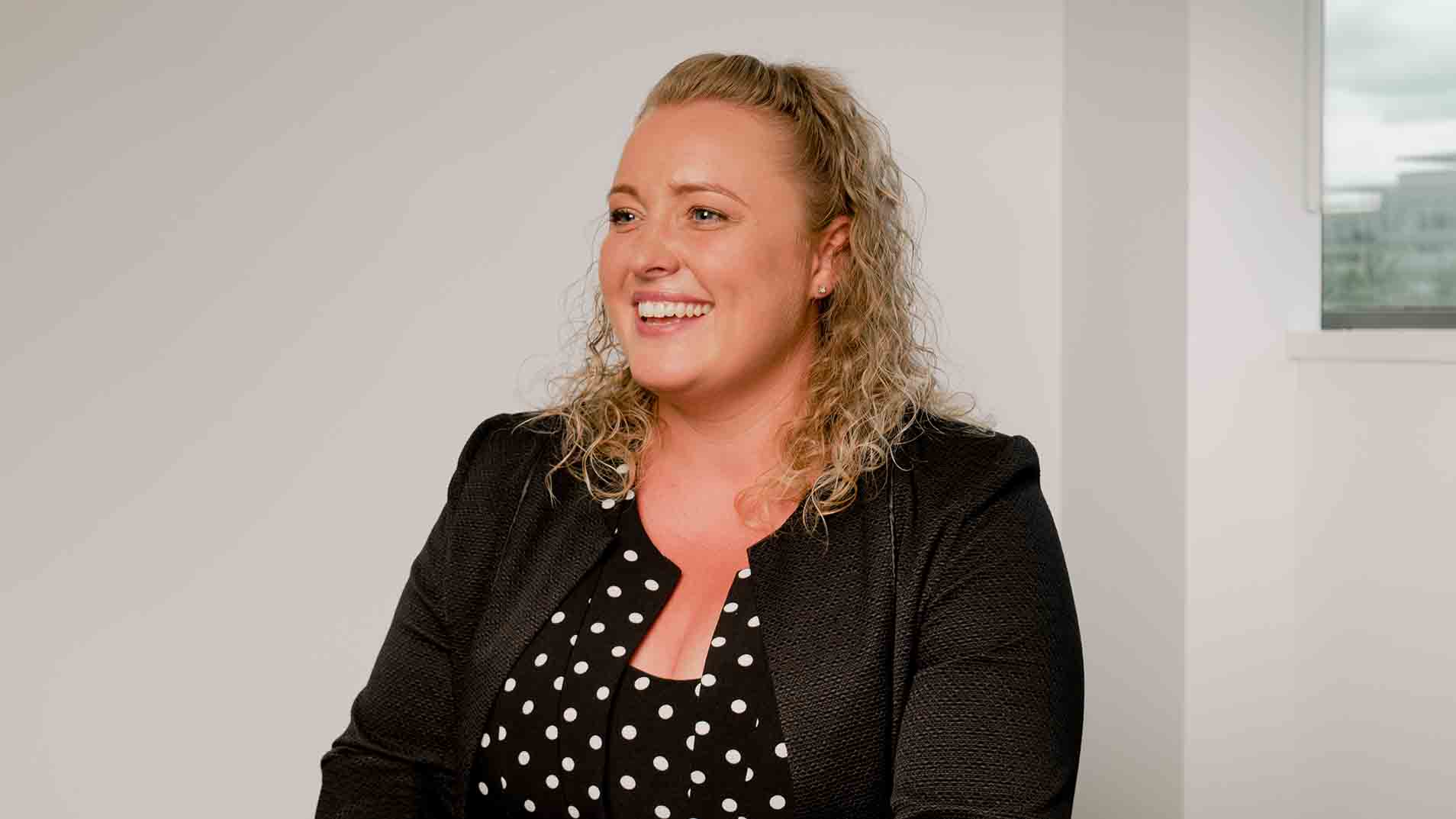 Financial Adviser, Olivia, smiling. 