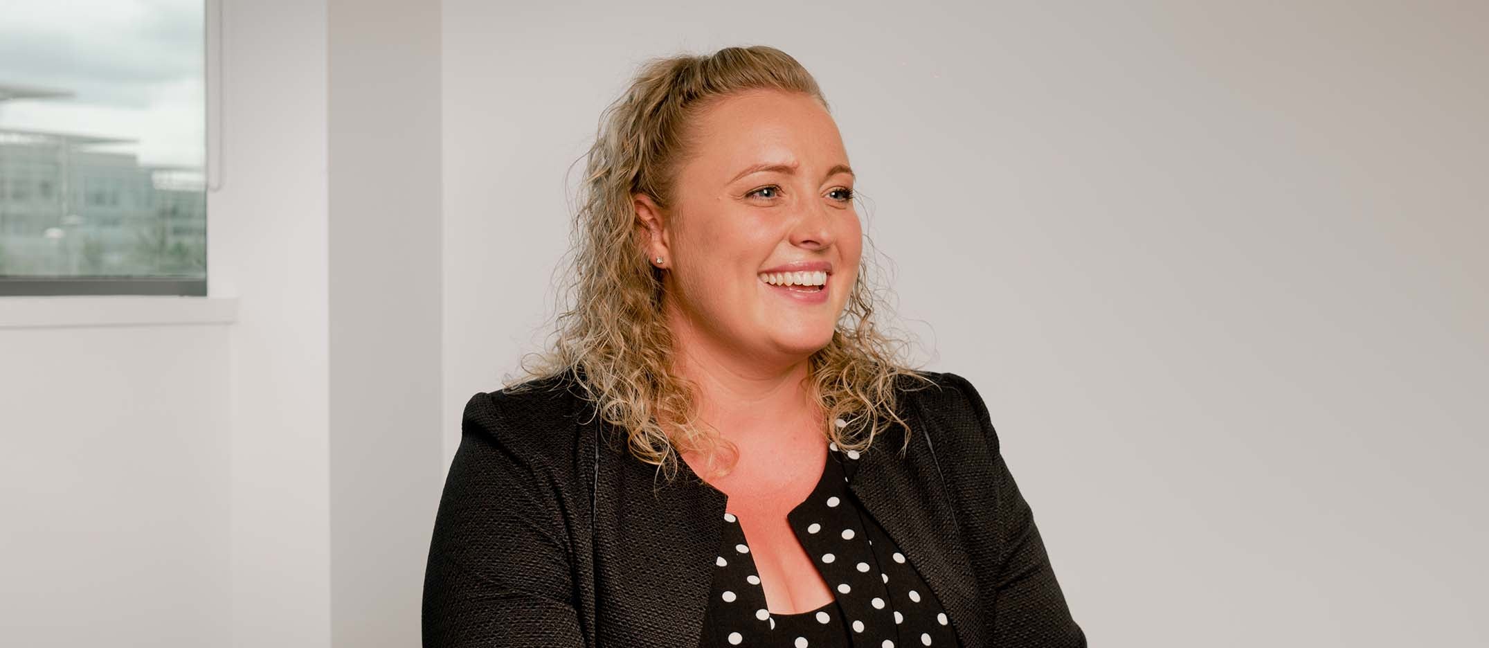 Newcastle Financial Adviser, Olivia Vickers, sat in their head office, smiling. 