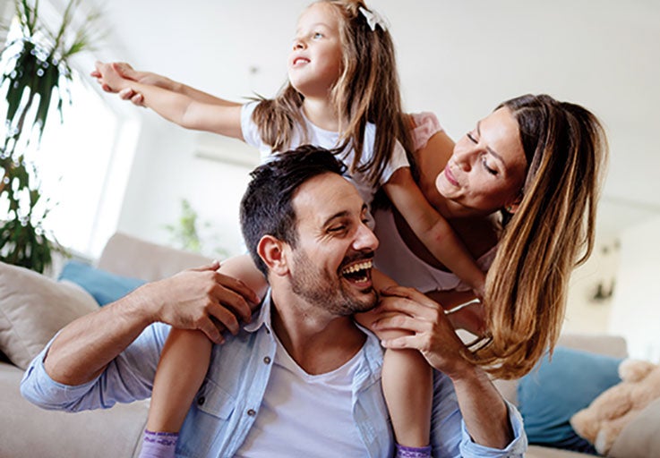 Mum, Dad, and daughter laughing together. 