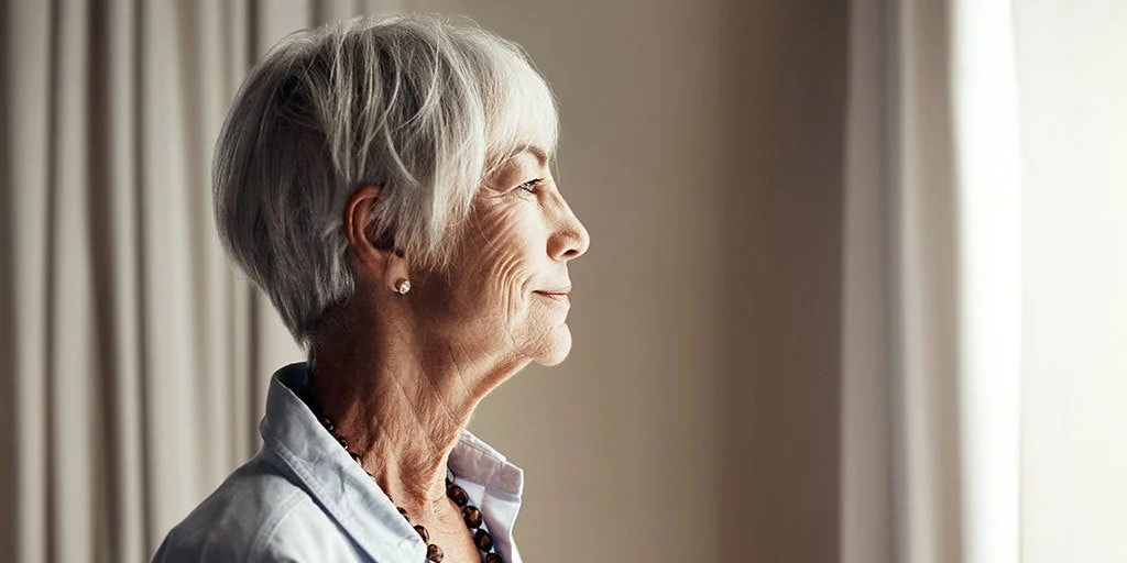 Woman looking content whilst looking out her window