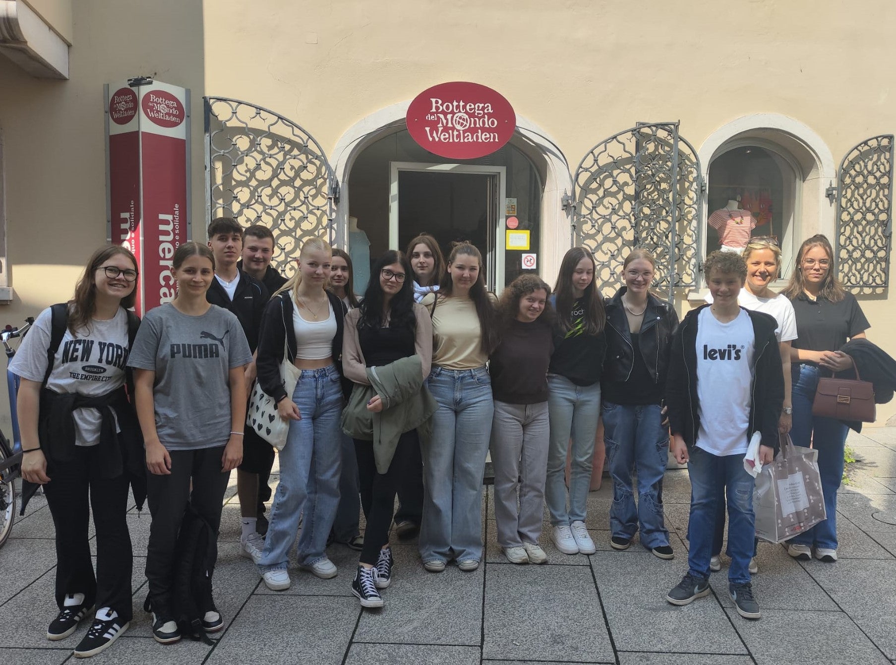 Schüler:innen der 2. Klasse mit Fachlehrerin Andrea Urban vor dem Weltladen Lana. Foto: FS Tisens