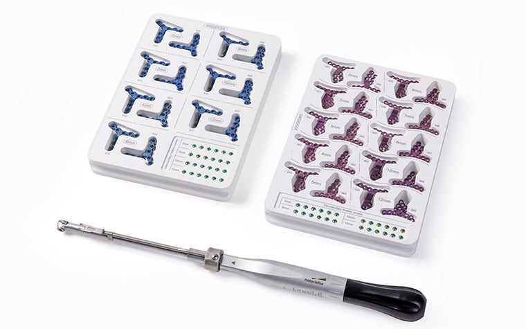 A Materialise orthognathic color-coded tool set with a screwdriver.