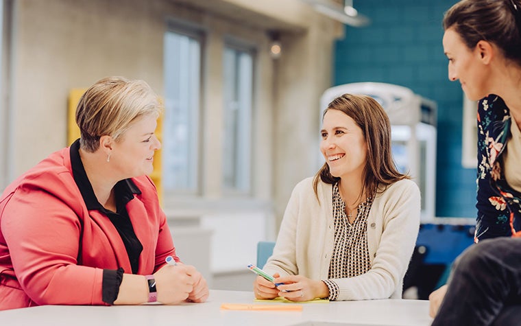 Three woman having a group discussion