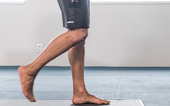 Man walking over a pressure plate in bare feet