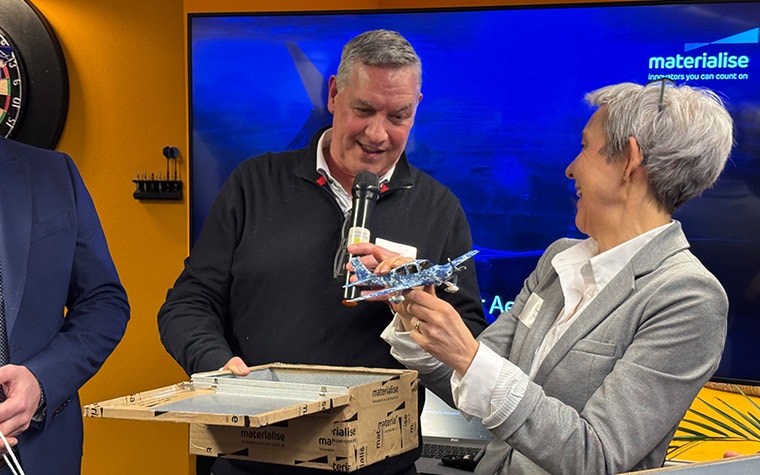 Materialise CEO Brigitte de Vet receiving a gift of a model airplane at the opening of Materialise's Aerospace Competence Center