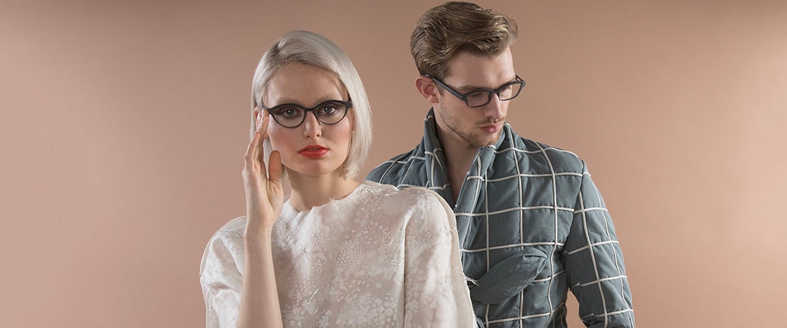 Female model looking at the camera, male model looking down, both wearing Hoet Cabrio Bi-Color eyewear