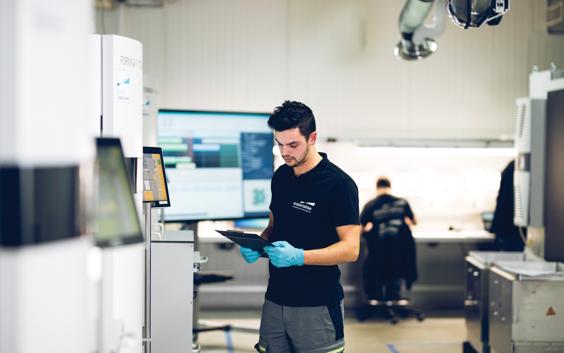 Man reviewing papers in a 3D printing production