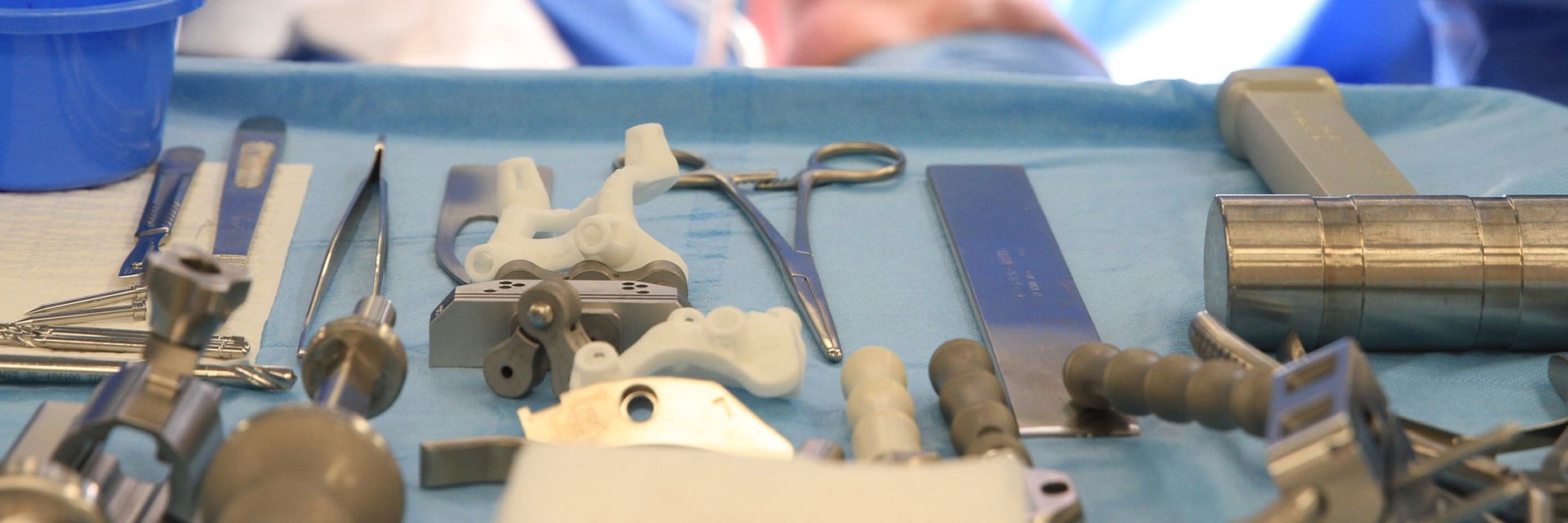 Surgical instruments laid out ready for use in knee surgery on the patient who is lying on the bed in the OR 